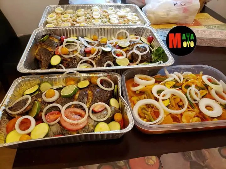 Trays of West African catering dishes prepared by MayaMoyo Dishes for a DMV event