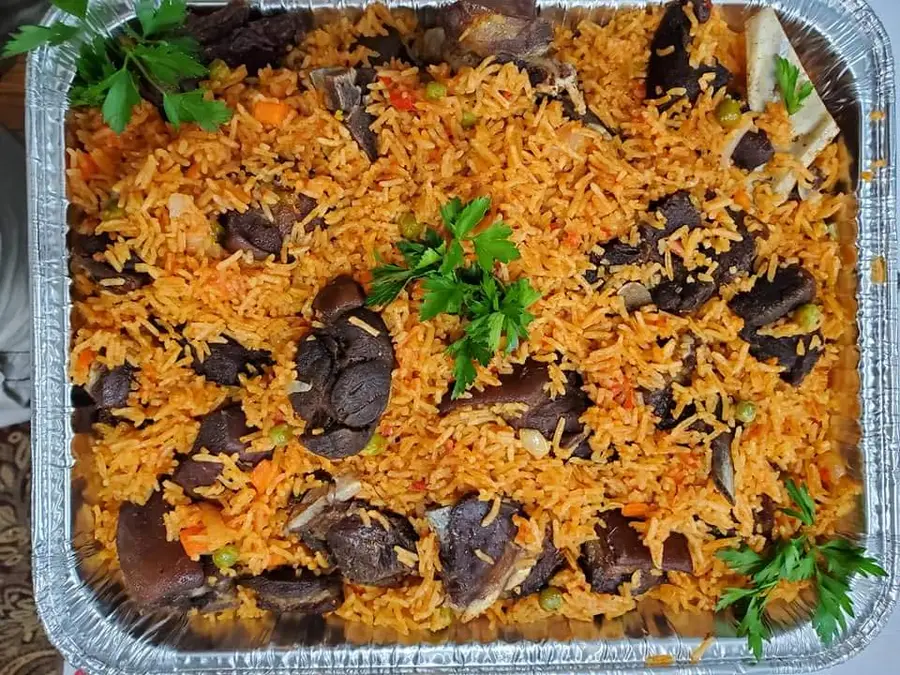 West African jollof rice with seasoned meat — MayaMoyo Dishes Gaithersburg catering